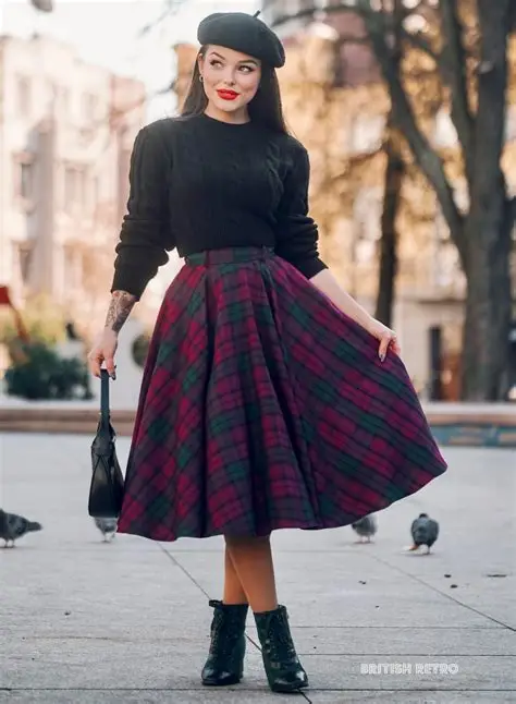 Woman standing outdoors wearing a black sweater, beret, and a red and green plaid skirt, holding a black handbag, with pigeons and trees in the background, urban setting, stylish and confident mood